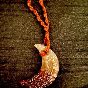 Gold flecked half moon hemp necklace.